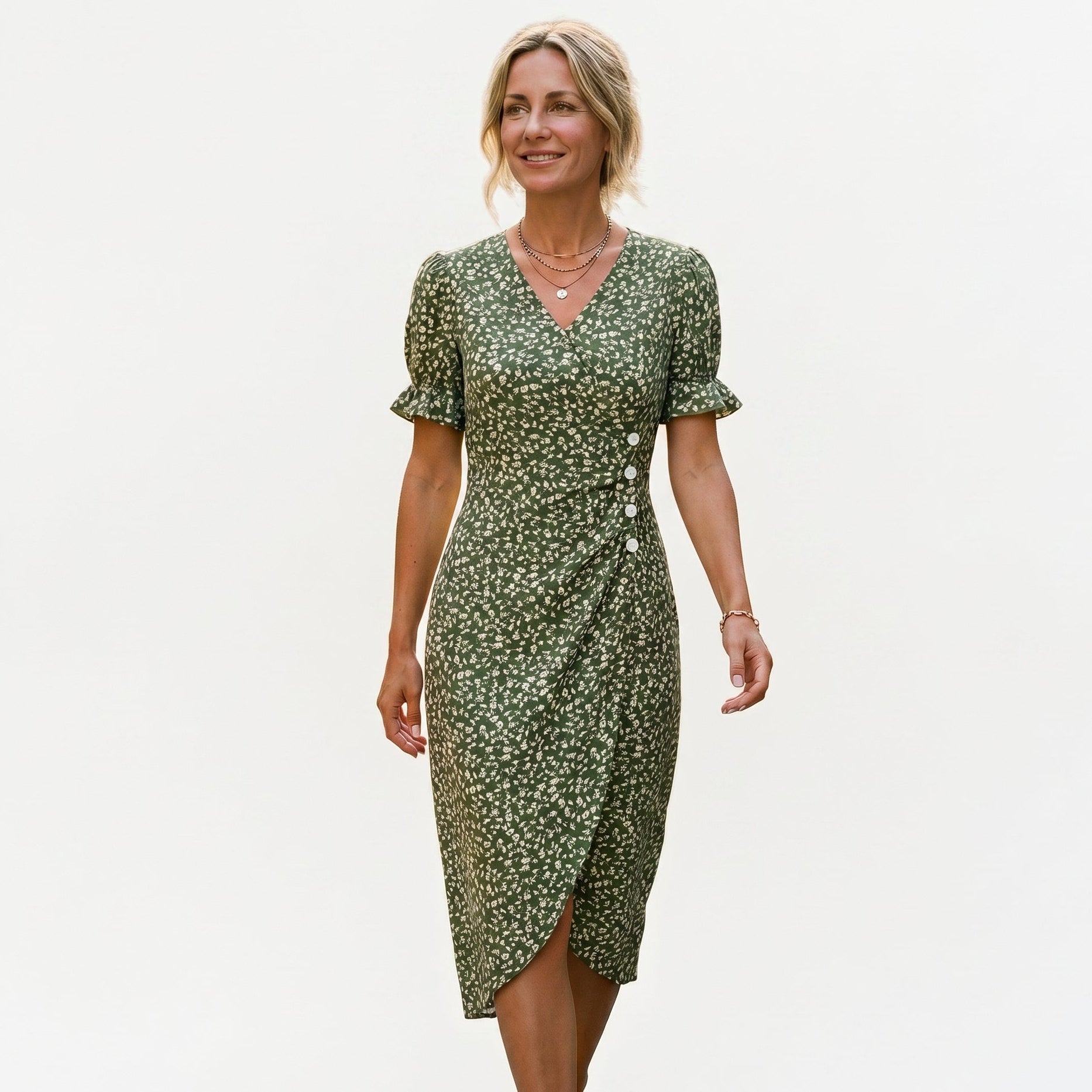 Green - Model wearing a floral V-neck midi dress with short ruffled sleeves and asymmetrical button detailing on a white background