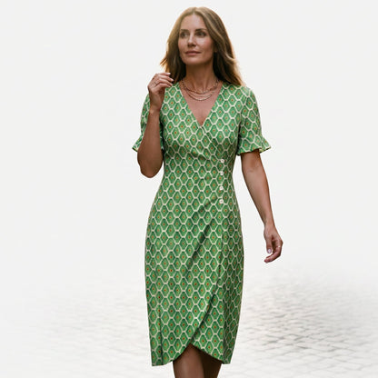 Light Green - Model wearing a floral V-neck midi dress with short ruffled sleeves and asymmetrical button detailing on a white background