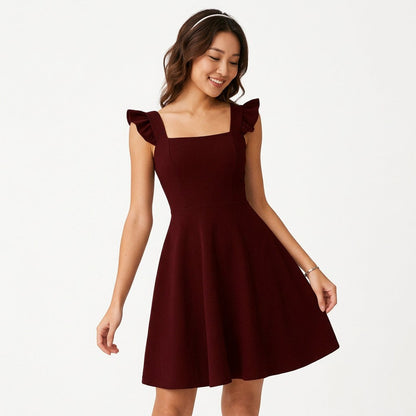 Claret - Model wearing a solid square-neck mini dress featuring ruffled cap sleeves, a fitted bodice, and a flared A-line skirt.