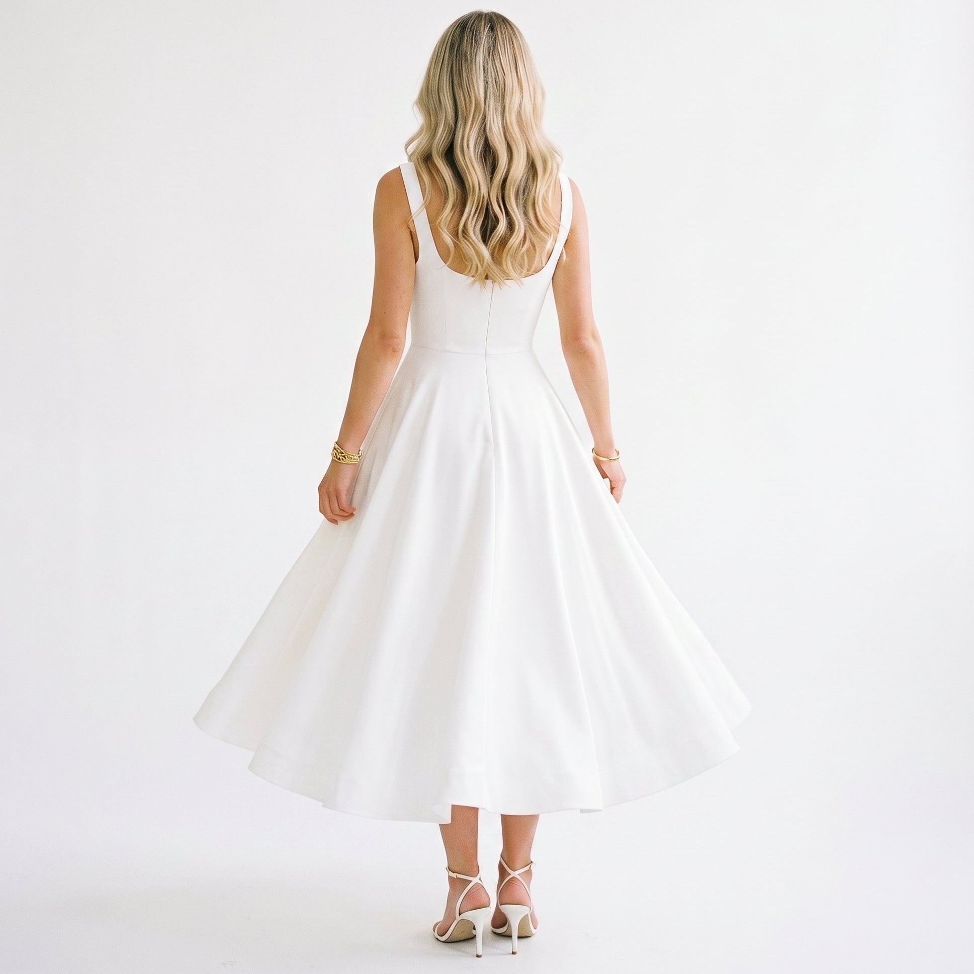 XXL - Model wearing a structured square-neck midi dress with a fitted bodice and full A-line skirt.