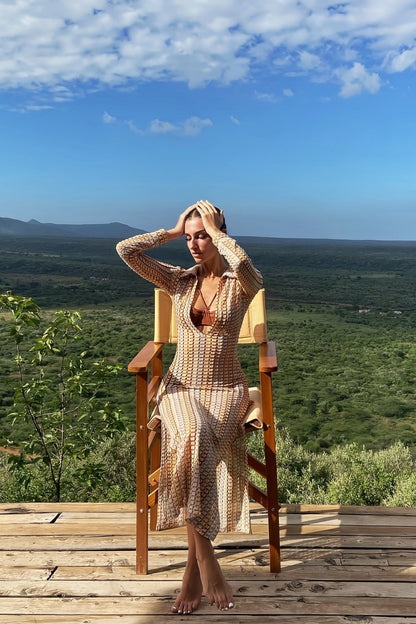 Woman in multicolored ribbed knit maxi dress with long sleeves and collared neckline