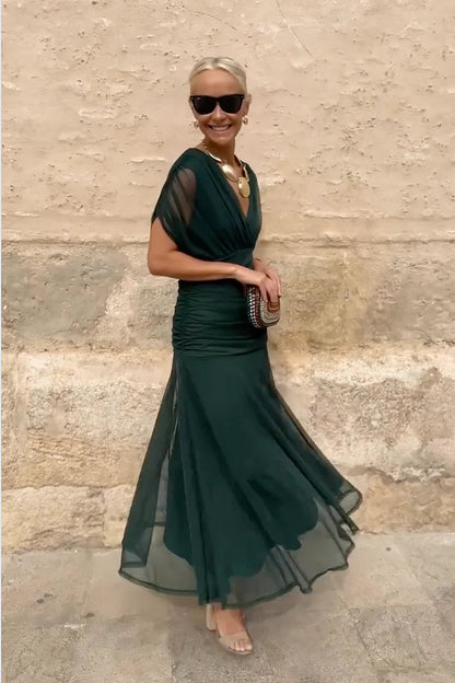 Woman in floral chiffon off-the-shoulder maxi dress