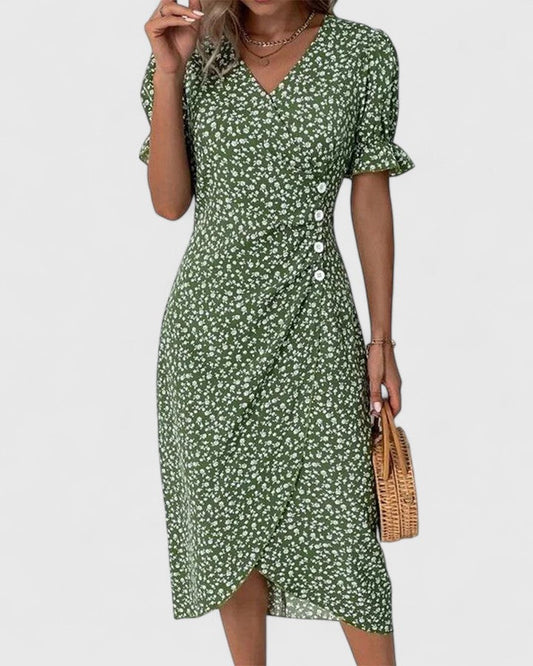 Green - A woman wearing a green midi dress with a white ditsy floral print, featuring short puff sleeves, a V-neckline, and decorative side buttons with a ruched wrap skirt.