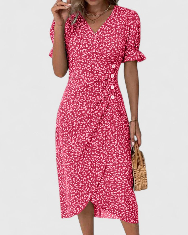 Red - A woman wearing a green midi dress with a white ditsy floral print, featuring short puff sleeves, a V-neckline, and decorative side buttons with a ruched wrap skirt.