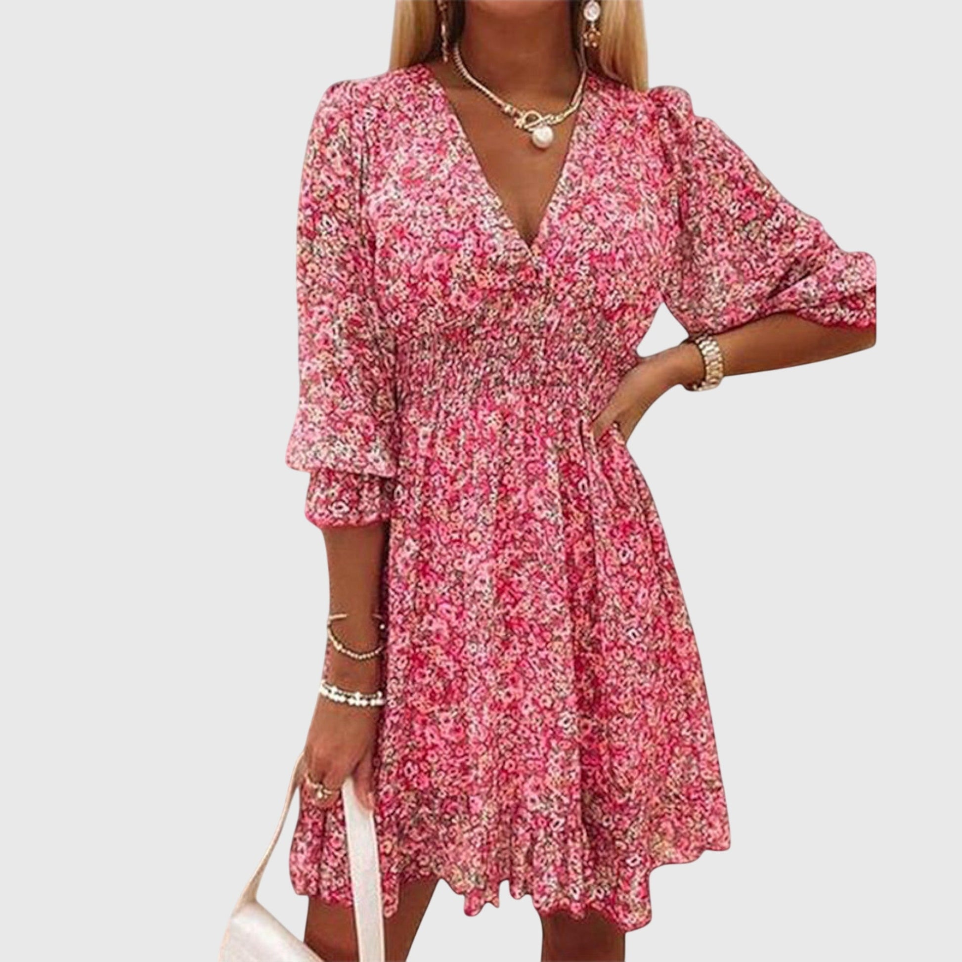Pink - A woman wearing a blue and white ditsy floral print sundress with a v-neckline, three-quarter sleeves, a cinched waist, and a ruffled hem, holding a white quilted clutch bag.