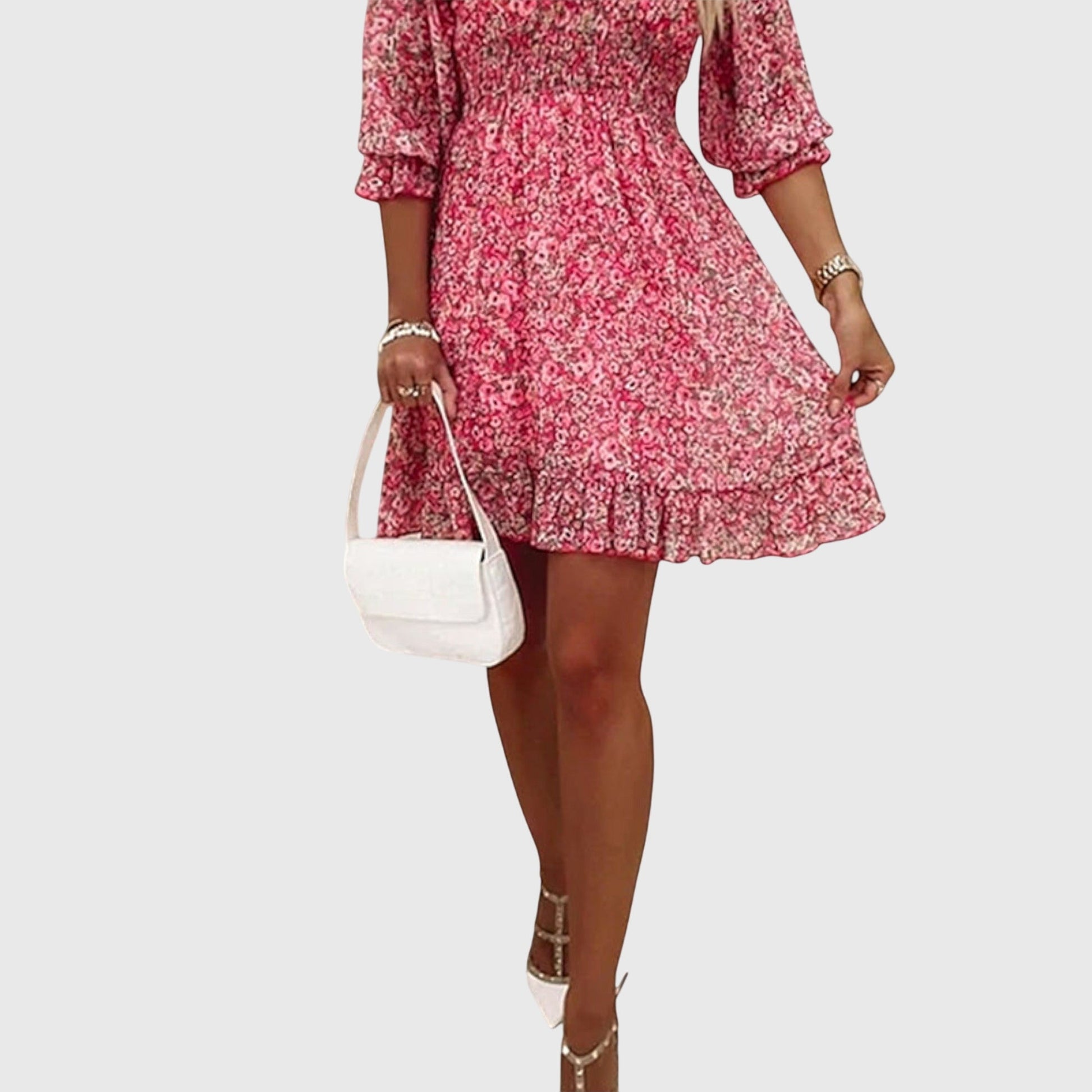 Pink - A woman wearing a blue and white ditsy floral print sundress with a v-neckline, three-quarter sleeves, a cinched waist, and a ruffled hem, holding a white quilted clutch bag.