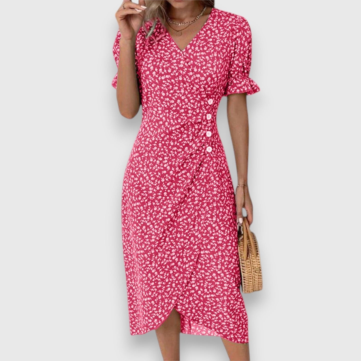 Red - A woman wearing a light blue midi sundress with a white ditsy floral print, featuring puff sleeves, a V-neckline, and an asymmetrical wrap skirt with button details.