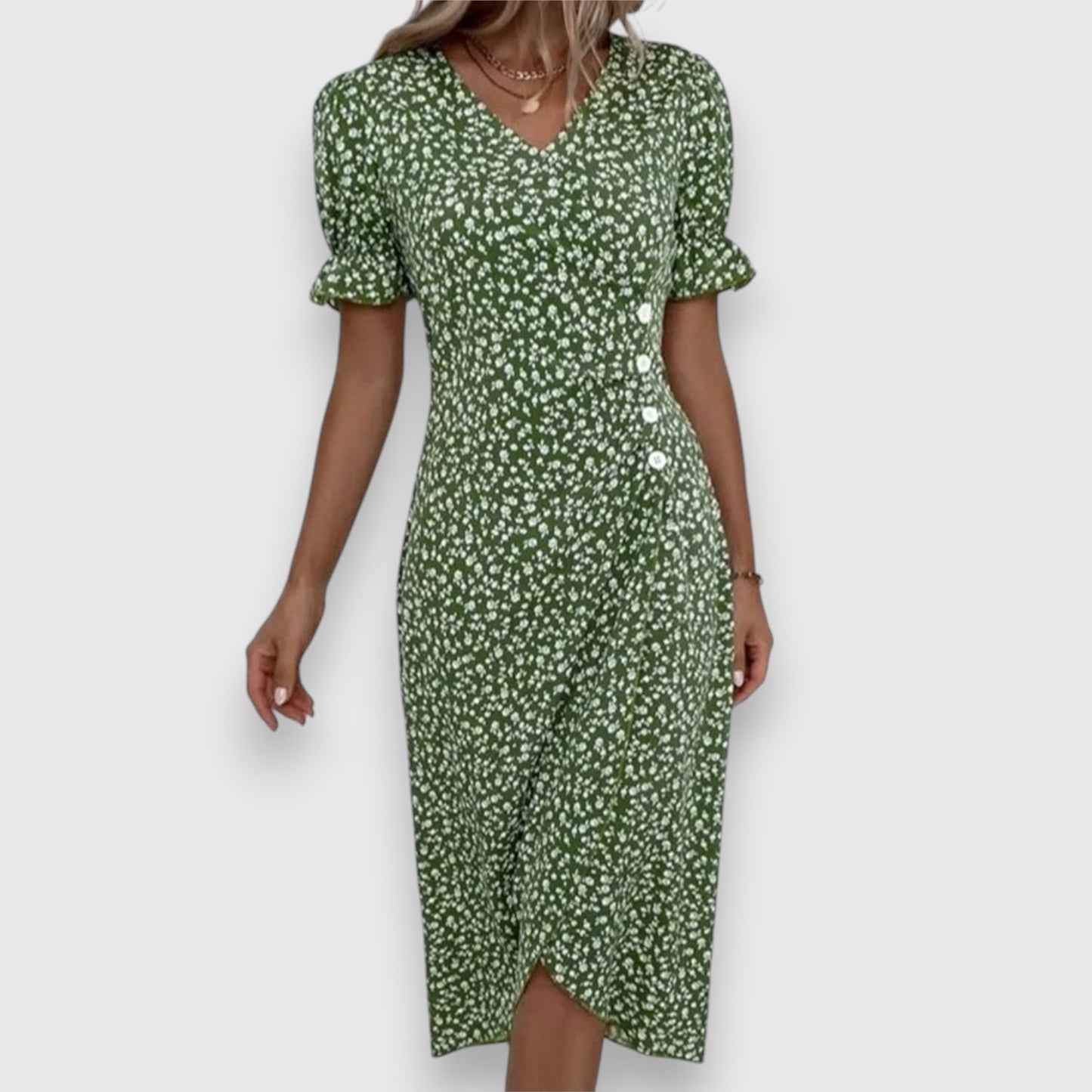 Black - A woman wearing a light blue midi sundress with a white ditsy floral print, featuring puff sleeves, a V-neckline, and an asymmetrical wrap skirt with button details.