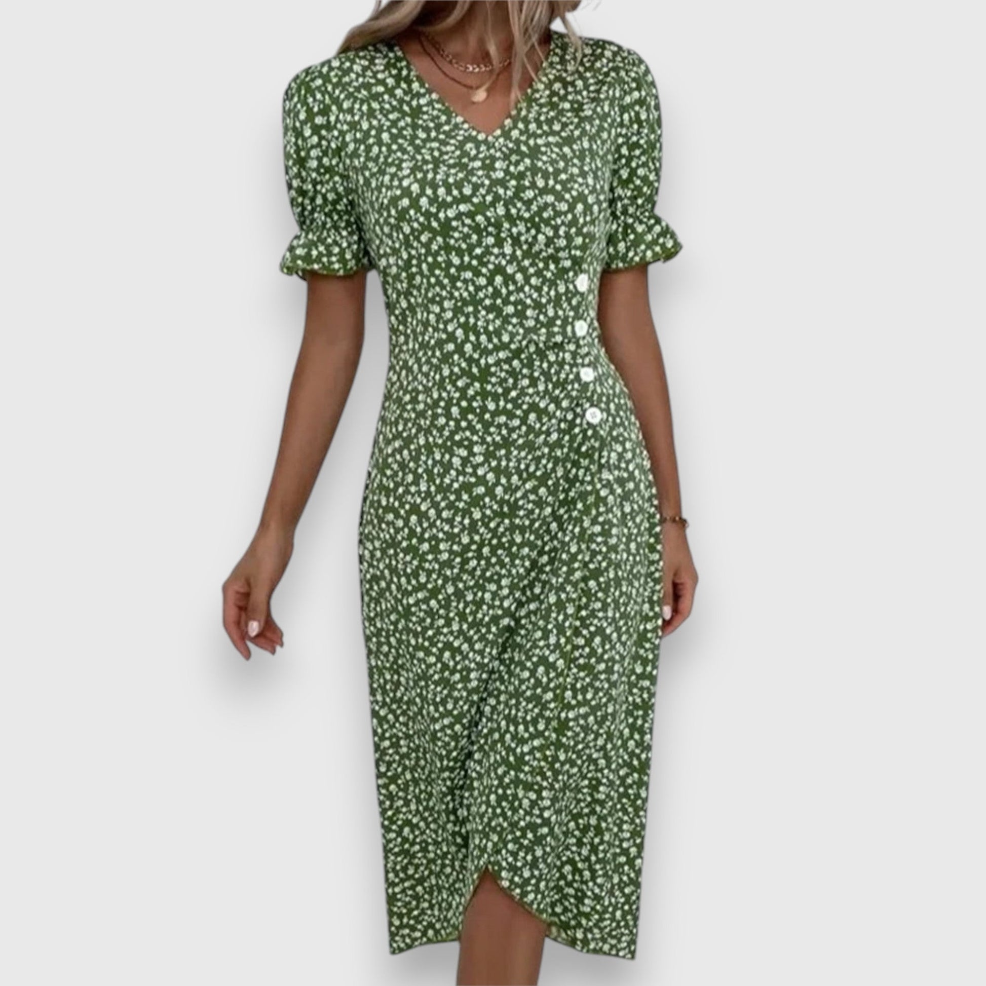 Black - A woman wearing a light blue midi sundress with a white ditsy floral print, featuring puff sleeves, a V-neckline, and an asymmetrical wrap skirt with button details.