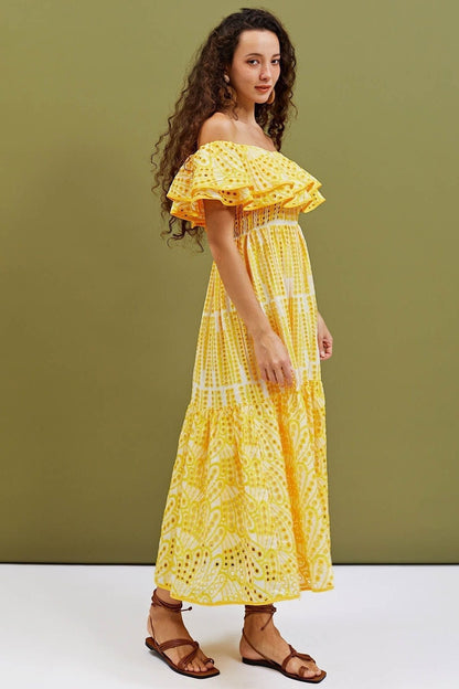 Woman wearing yellow eyelet embroidered off-the-shoulder maxi dress