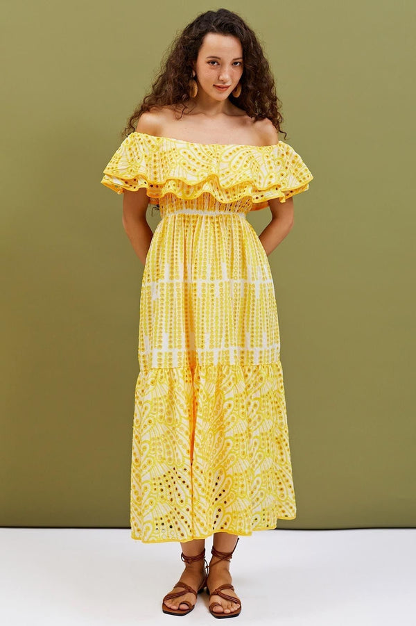 Woman wearing yellow eyelet embroidered off-the-shoulder maxi dress
