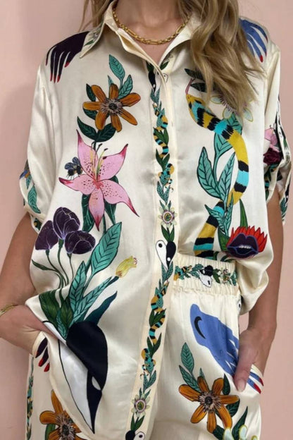 Woman wearing ivory satin pajama set with floral and yin yang print