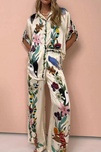 Woman wearing ivory satin pajama set with floral and yin yang print