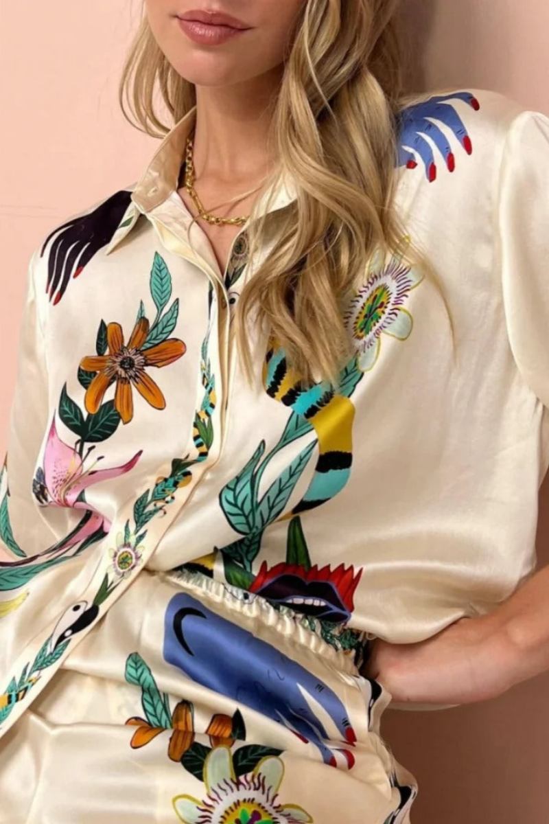 Woman wearing ivory satin pajama set with floral and yin yang print