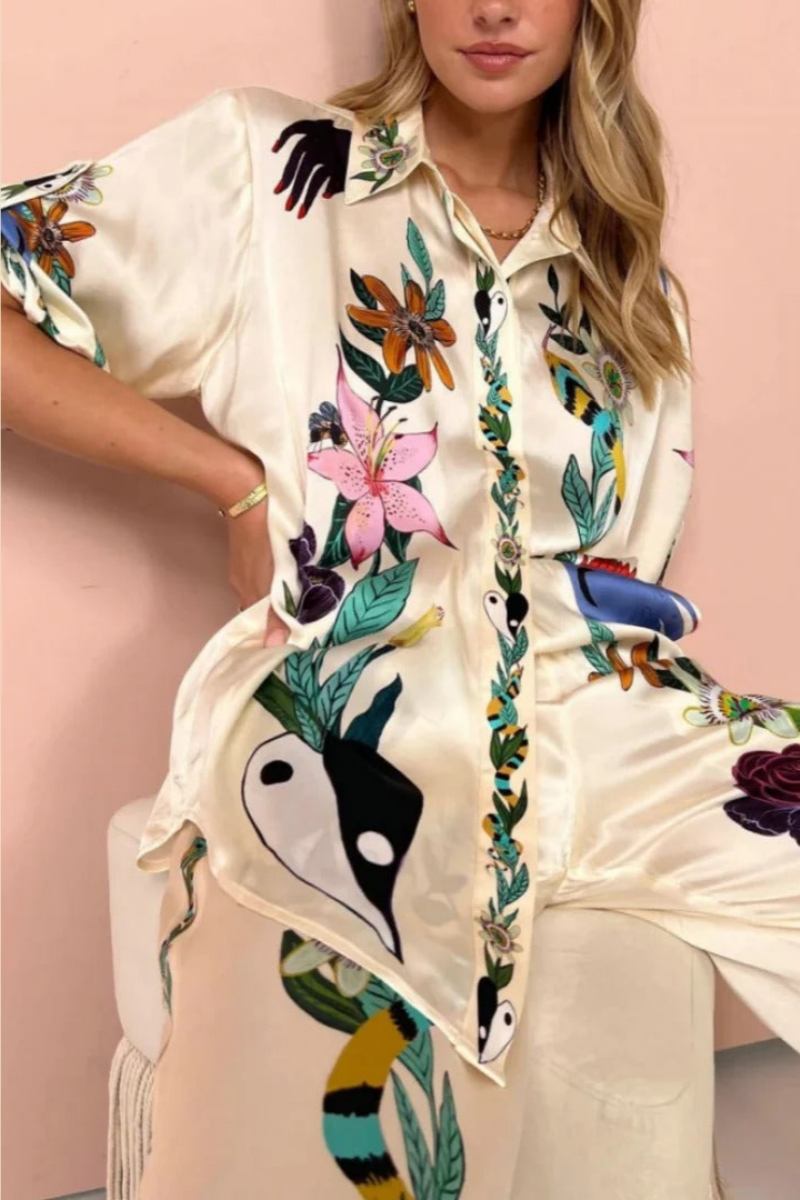 Woman wearing ivory satin pajama set with floral and yin yang print