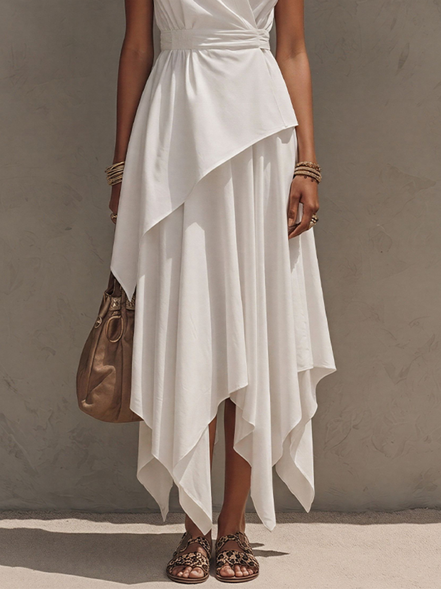 Off-White - Woman wearing a sleeveless, collared midi dress with a wrap bodice and asymmetrical handkerchief hem, styled with sandals and a handbag.
