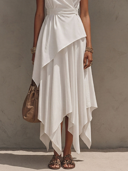 Off-White - Woman wearing a sleeveless, collared midi dress with a wrap bodice and asymmetrical handkerchief hem, styled with sandals and a handbag.