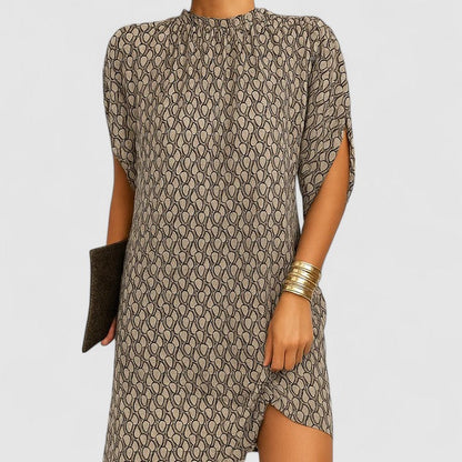 Beige Pattern - A woman wearing a dusty pink crepe shift dress featuring a gathered mock neckline, draped cap sleeves, and a relaxed silhouette.