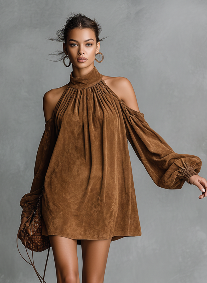Pink - Model wearing a draped faux-suede mini dress with a high neckline, cold-shoulder cutouts, and long bishop sleeves, styled with tall western boots.