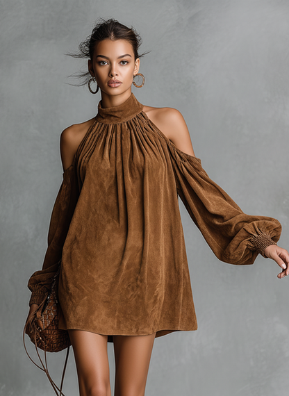 Pink - Model wearing a draped faux-suede mini dress with a high neckline, cold-shoulder cutouts, and long bishop sleeves, styled with tall western boots.