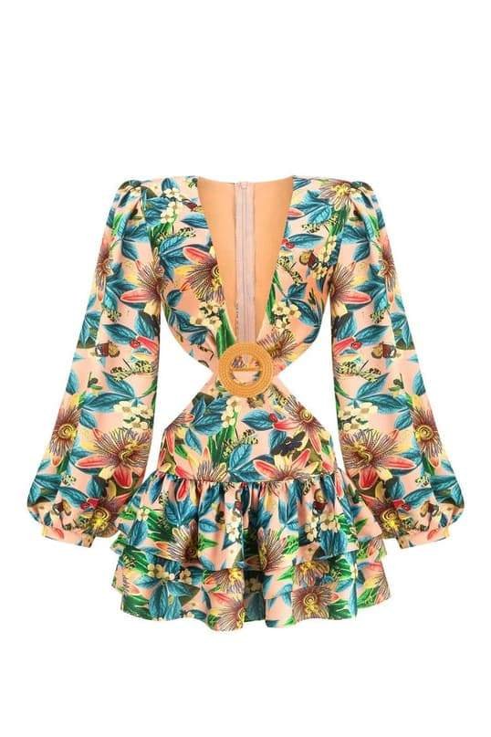 Woman wearing floral mini dress with cutout waist