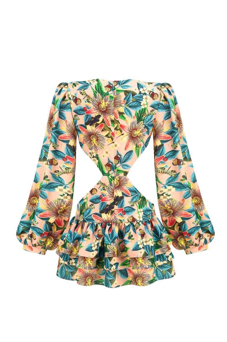Woman wearing floral mini dress with cutout waist
