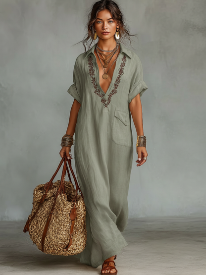 Light Green - Model wearing a relaxed fit woven maxi dress with a collared V-neckline, intricate front embroidery, and a single patch pocket, styled with a woven tote bag.