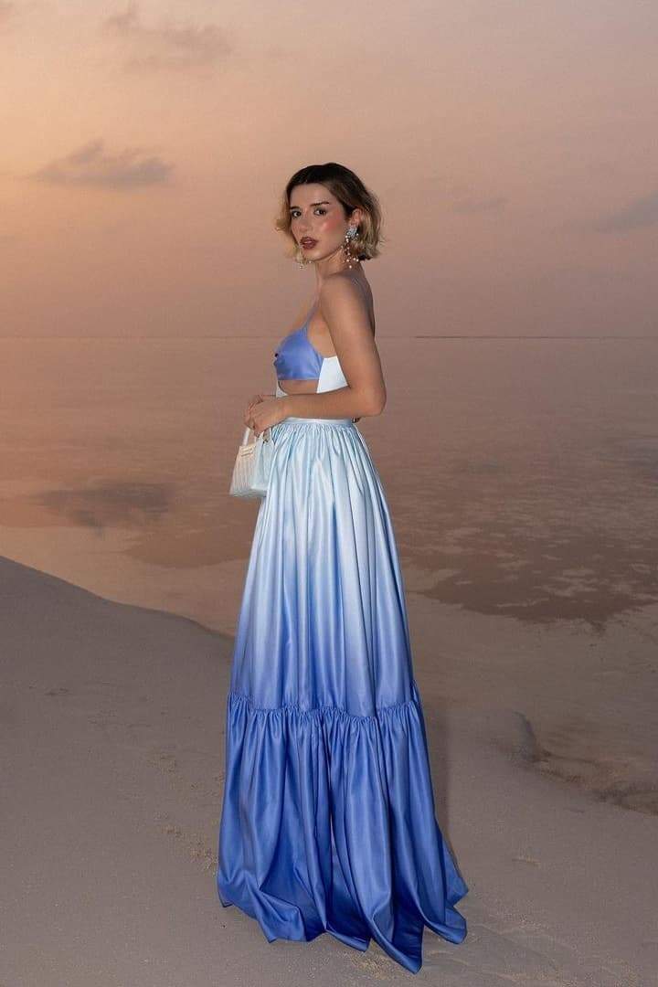 Woman wearing blue ombre satin maxi dress with cutout waist