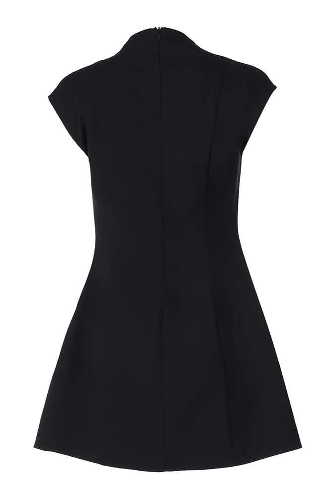 Woman in black crepe mini dress with plunging neckline