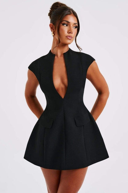 Woman in black crepe mini dress with plunging neckline