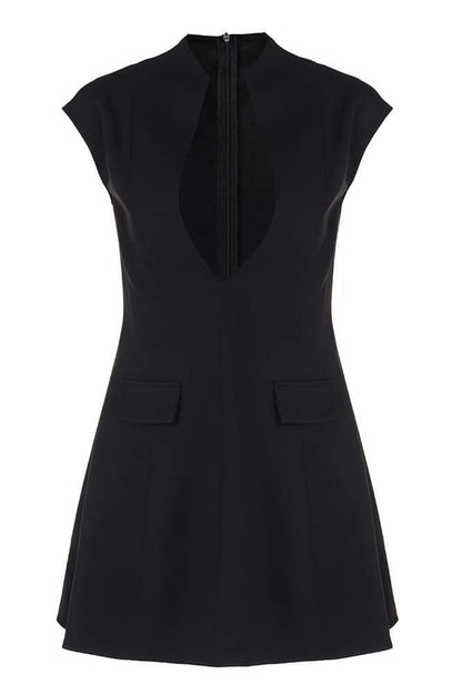 Woman in black crepe mini dress with plunging neckline