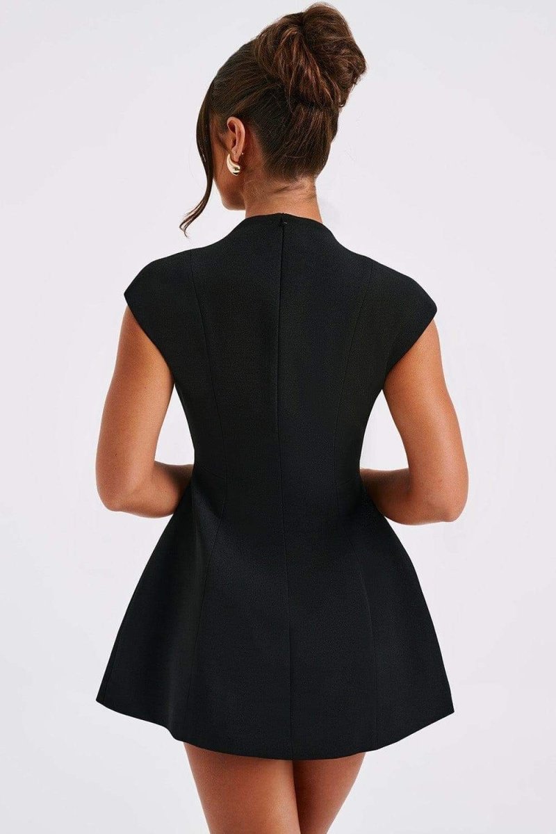 Woman in black crepe mini dress with plunging neckline