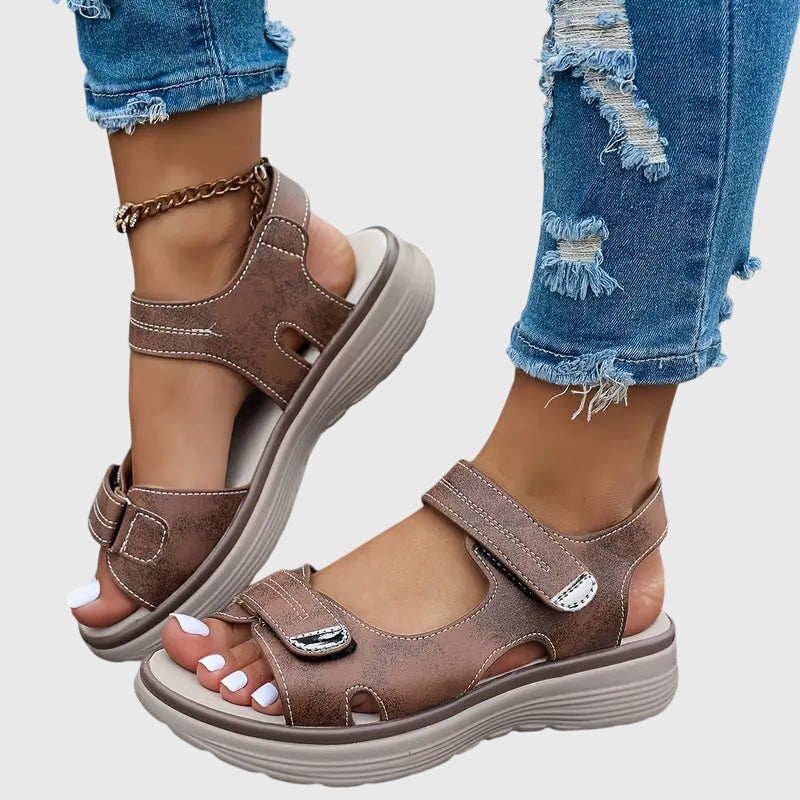 Sepia - Textured faux-leather platform sandals featuring adjustable hook-and-loop straps, contrast stitching, and a thick cushioned sole.