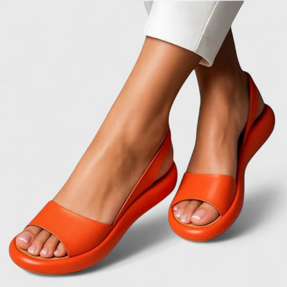 Orange - Women's smooth faux-leather platform sandals featuring a wide upper strap, open toe, and an integrated slingback strap on a thick cushioned sole.