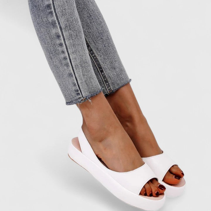 White - Women's smooth faux-leather platform sandals featuring a wide upper strap, open toe, and an integrated slingback strap on a thick cushioned sole.