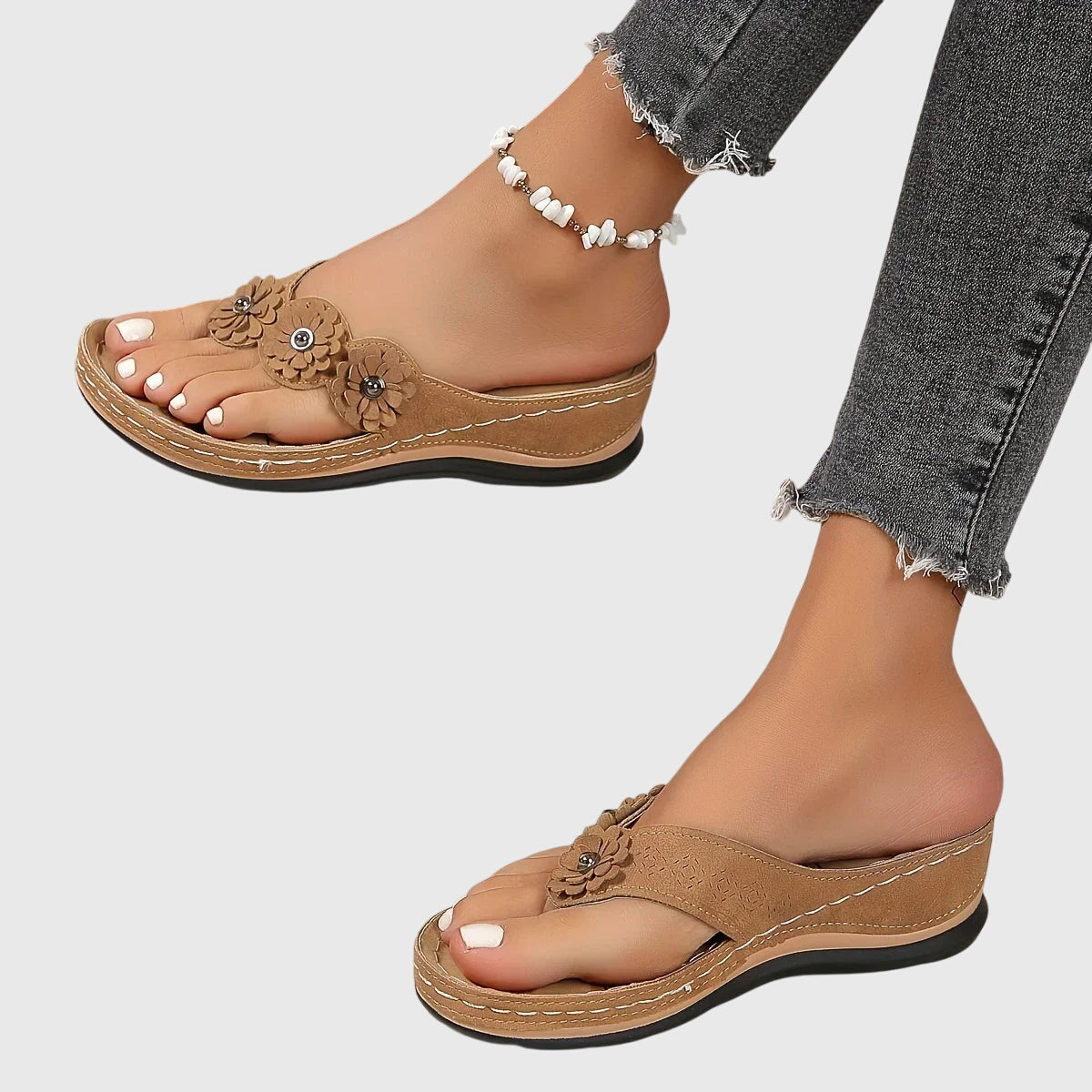 Black - Faux-suede slip-on wedge sandals featuring three floral appliques across the instep, contrast stitching details, and a contoured comfort footbed.