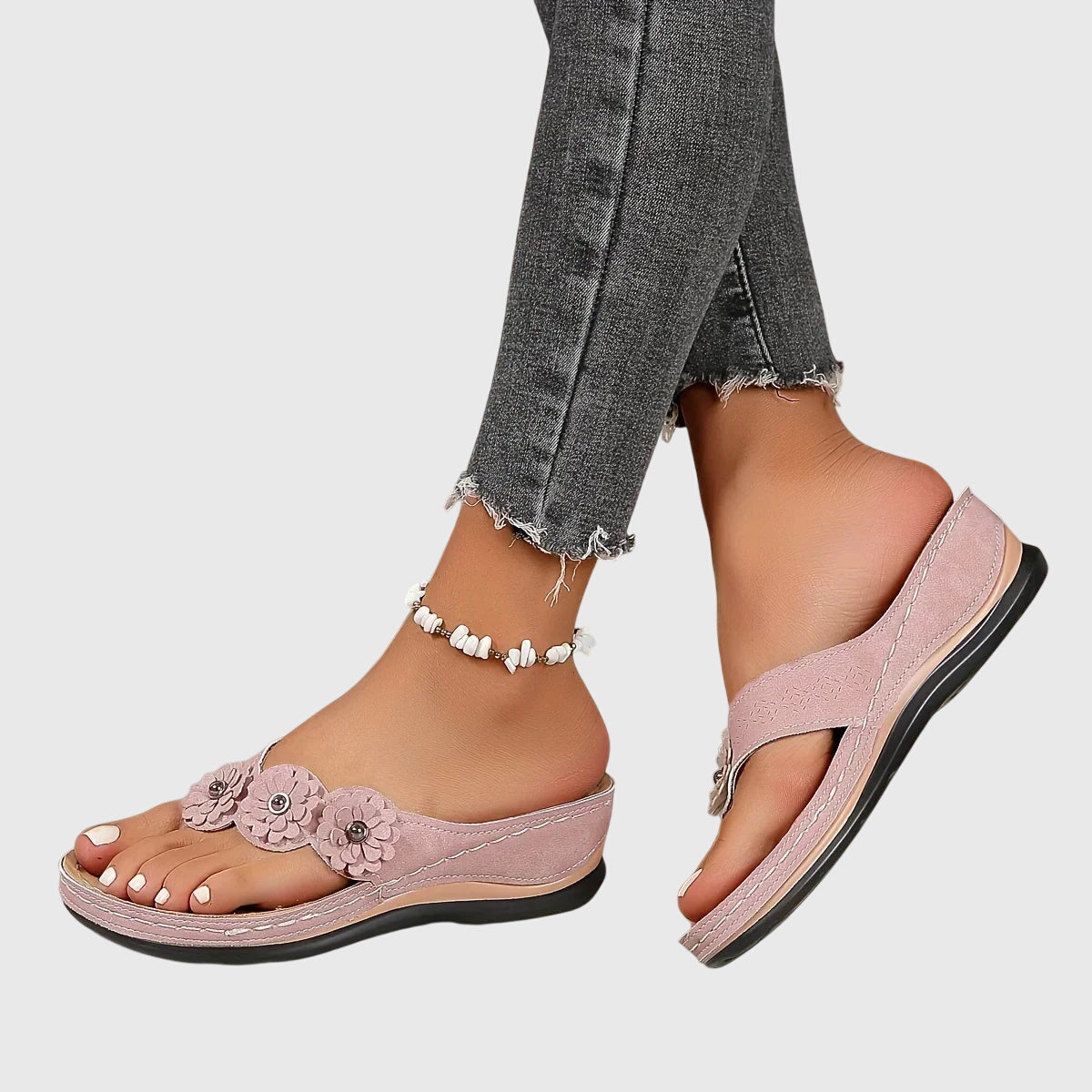Black - Faux-suede slip-on wedge sandals featuring three floral appliques across the instep, contrast stitching details, and a contoured comfort footbed.