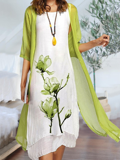 Light Green - Woman wearing a sleeveless midi dress with a large floral print and a matching sheer, open-front long cardigan.