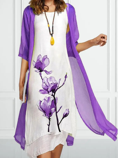 Purple - Woman wearing a sleeveless midi dress with a large floral print and a matching sheer, open-front long cardigan.