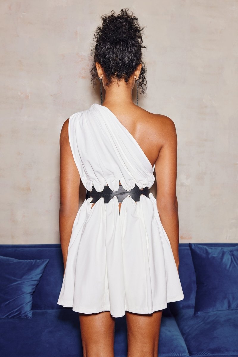 Woman in white one-shoulder mini dress with cutout waist