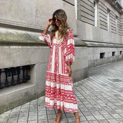 Red - Woman wearing a long sleeve geometric print tiered maxi dress with puff sleeves walking on a sidewalk