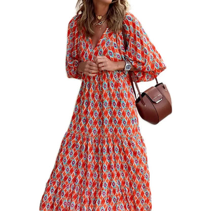 Orange - Woman wearing a long sleeve geometric print tiered maxi dress with puff sleeves walking on a sidewalk
