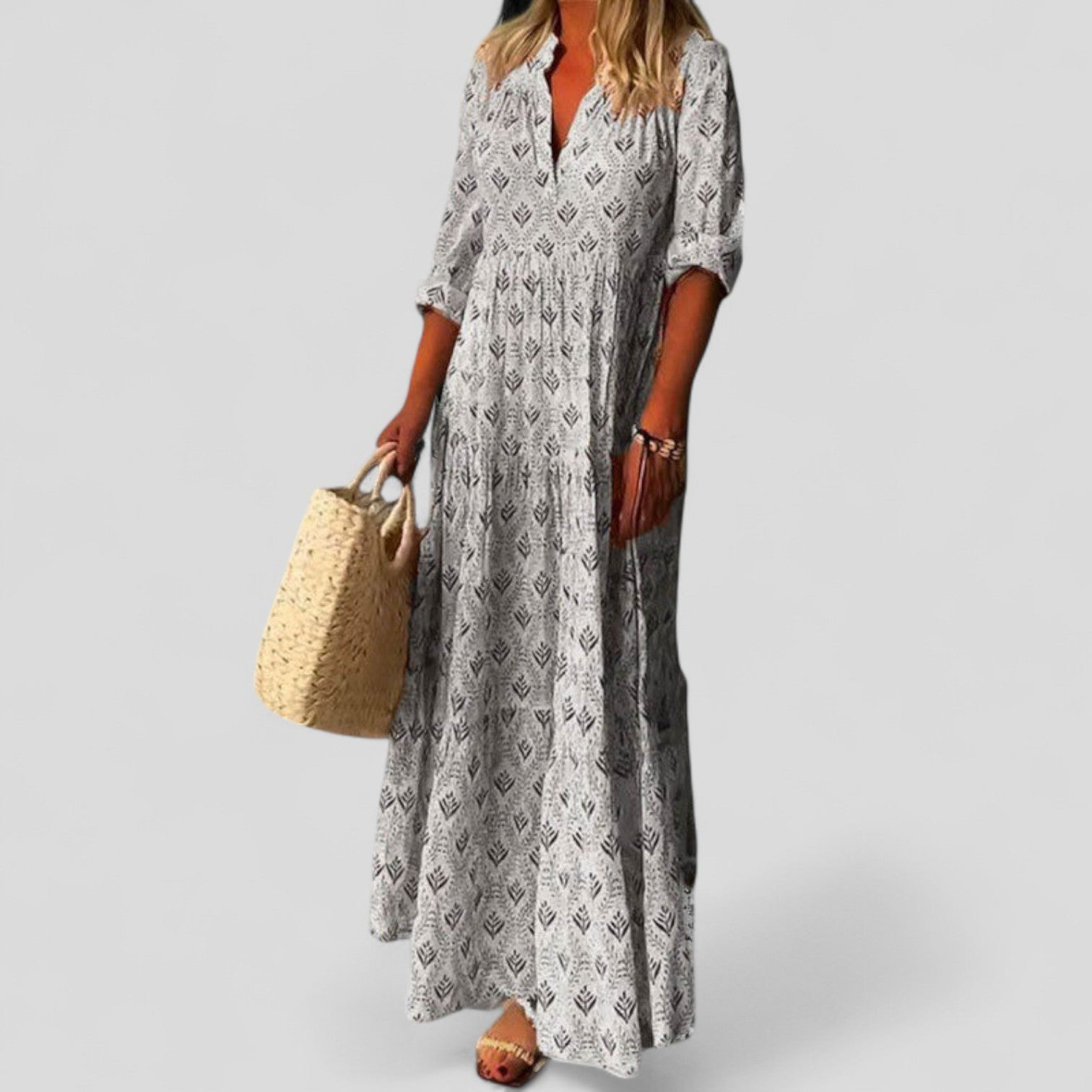 White - Women's long maxi dress featuring an all-over geometric print, 3/4 sleeves, and a tiered skirt.