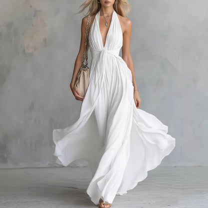 White - A woman wearing a dusty lavender chiffon halter maxi dress with a plunging V-neckline, pleated bodice, and a flowing floor-length skirt.