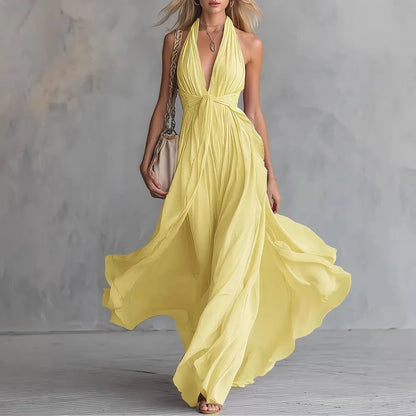 Yellow - A woman wearing a dusty lavender chiffon halter maxi dress with a plunging V-neckline, pleated bodice, and a flowing floor-length skirt.