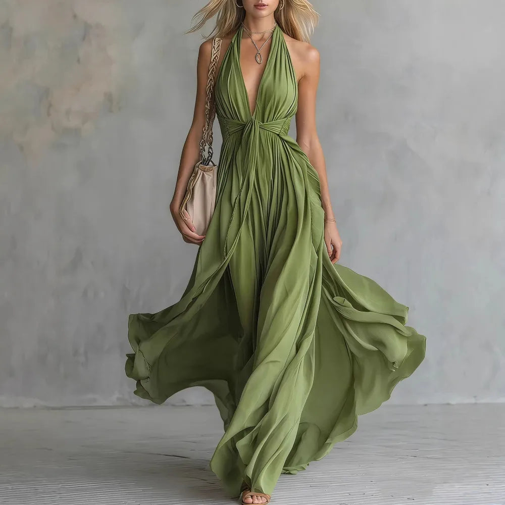 Green - A woman wearing a dusty lavender chiffon halter maxi dress with a plunging V-neckline, pleated bodice, and a flowing floor-length skirt.
