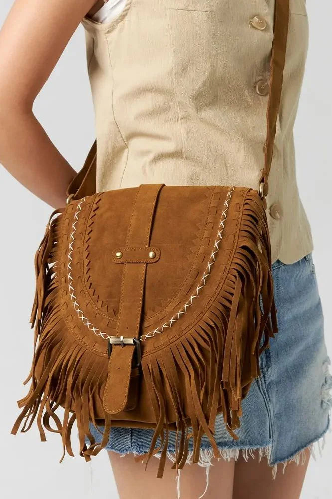 Front view of tan suede saddle bag with fringe detail