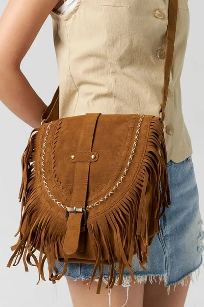 Front view of tan suede saddle bag with fringe detail