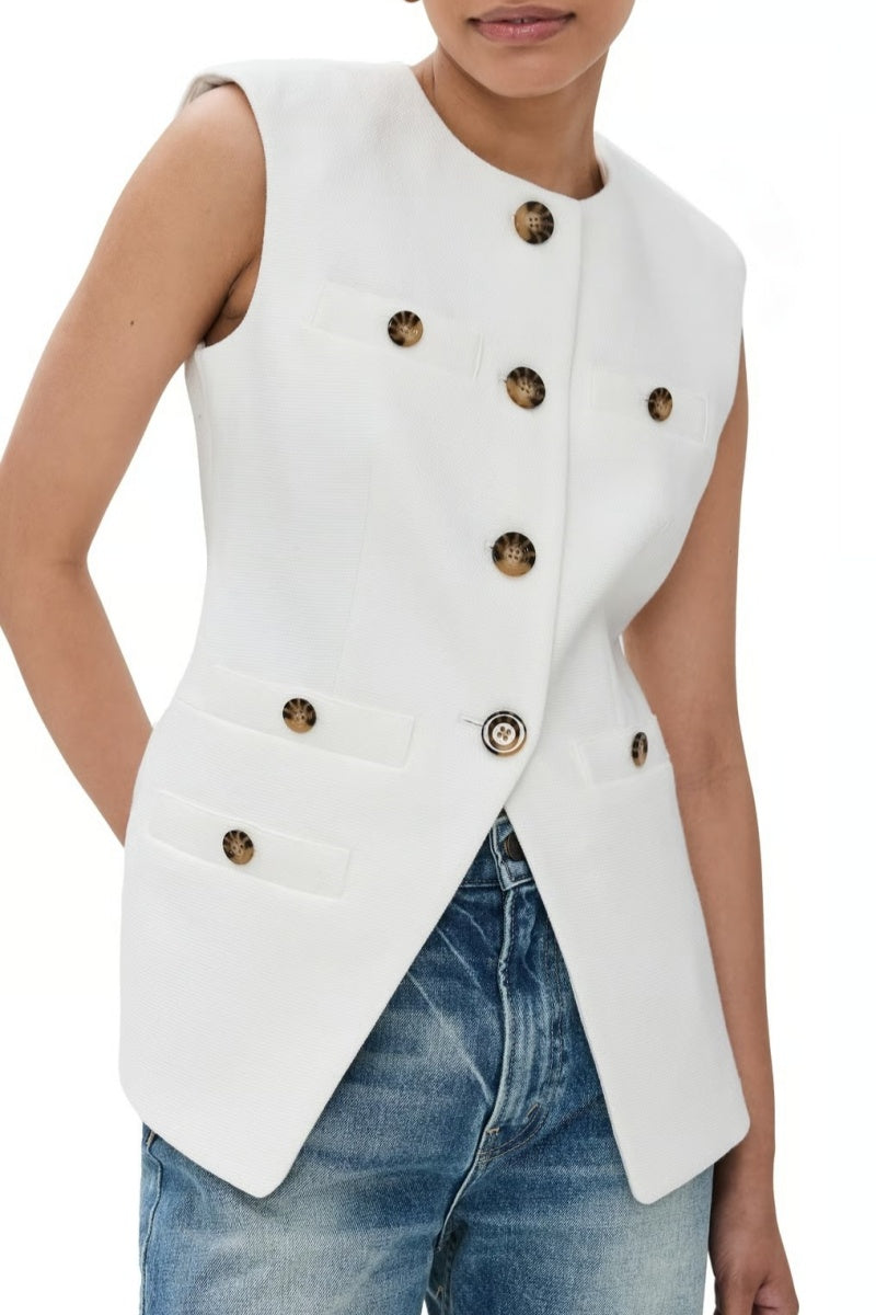 Woman wearing white boucle vest with tortoise buttons