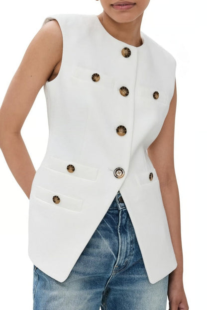 Woman wearing white boucle vest with tortoise buttons